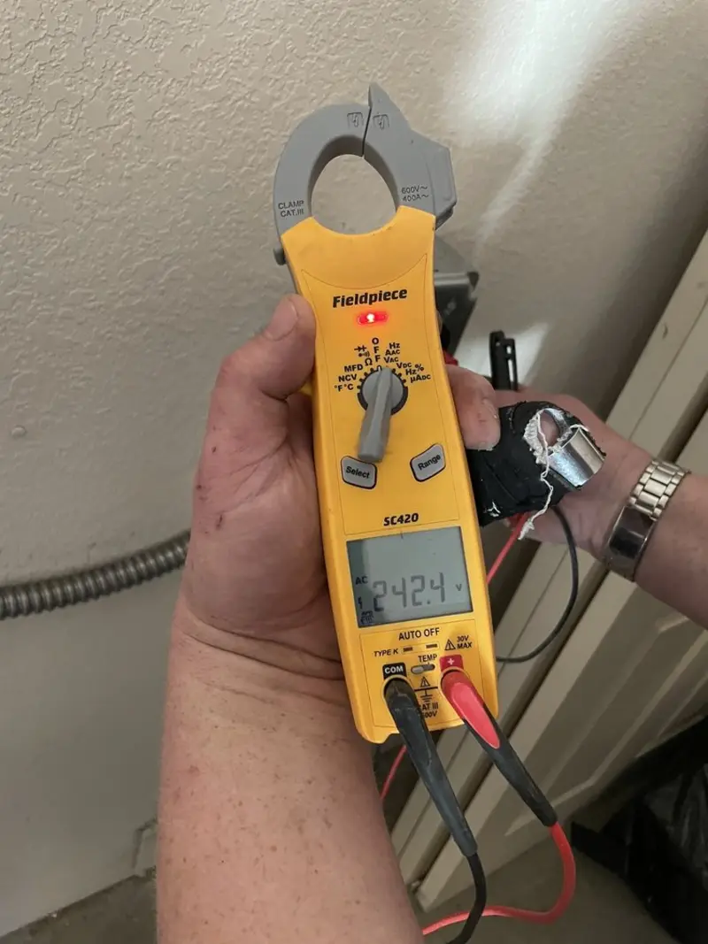 Voltage testing with clamp meter during Ceiling Fan Installation in Barre
